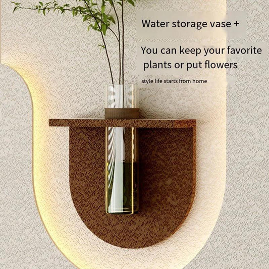 Wall-mounted water storage vase with a plant on a neutral background