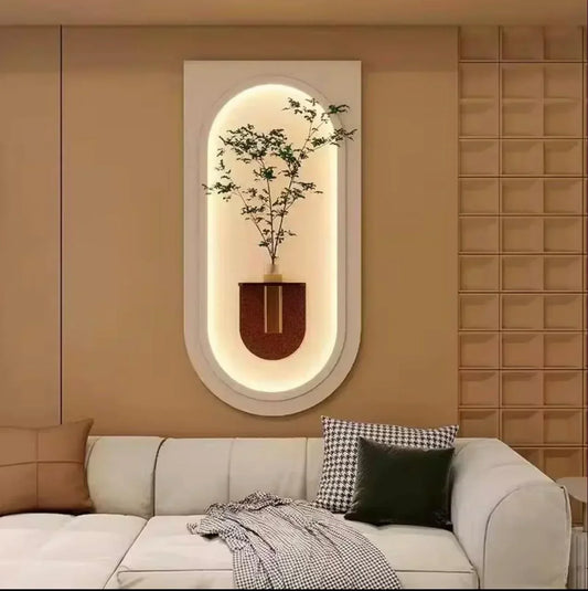 Decorative wall mirror with plant on a beige wall above a sofa.